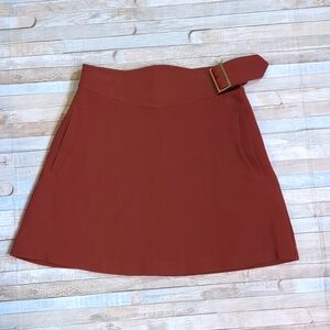 Chili color A-line mini skirt with wide waistband, gold buckle, pockets